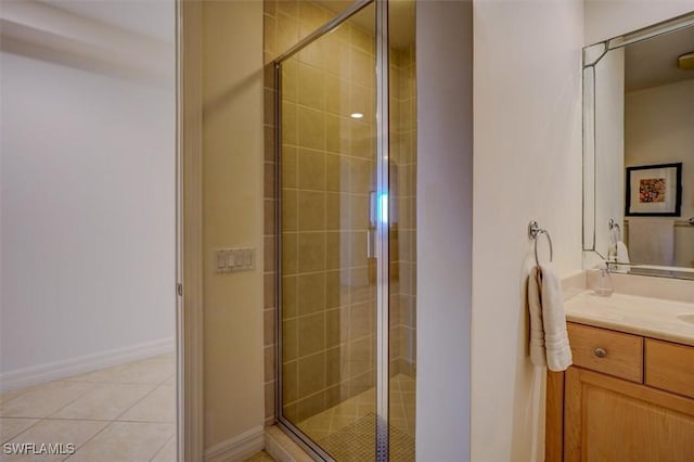 bathroom featuring vanity, tile patterned floors, and walk in shower