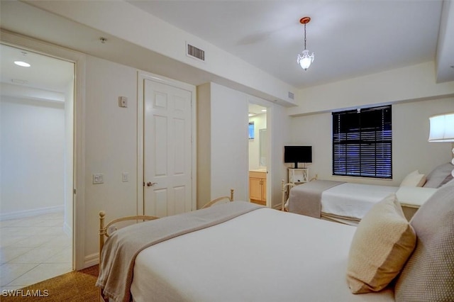 bedroom featuring tile patterned flooring and ensuite bath