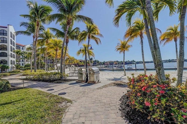 view of property's community with exterior kitchen and a water view