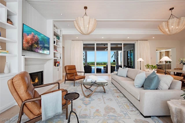 55 13th Ave S, Naples, FL 34102 - living room with a glass covered fireplace, wood finished floors, built in features, and recessed lighting