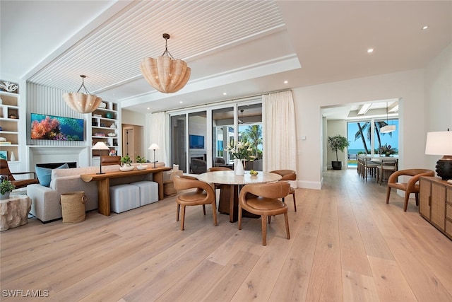 dining area featuring light hardwood / wood-style flooring and a chandelier