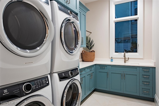 washroom with cabinets, independent washer and dryer, sink, and light tile patterned floors