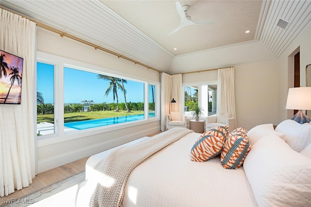 bedroom with ceiling fan, ornamental molding, and hardwood / wood-style flooring