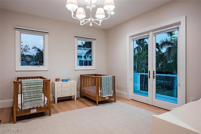 living area featuring hardwood / wood-style floors and a notable chandelier