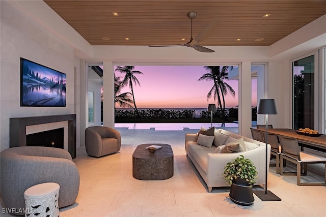 living room with ceiling fan and wooden ceiling