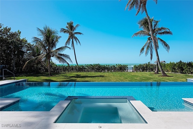 view of swimming pool with a lawn and an in ground hot tub