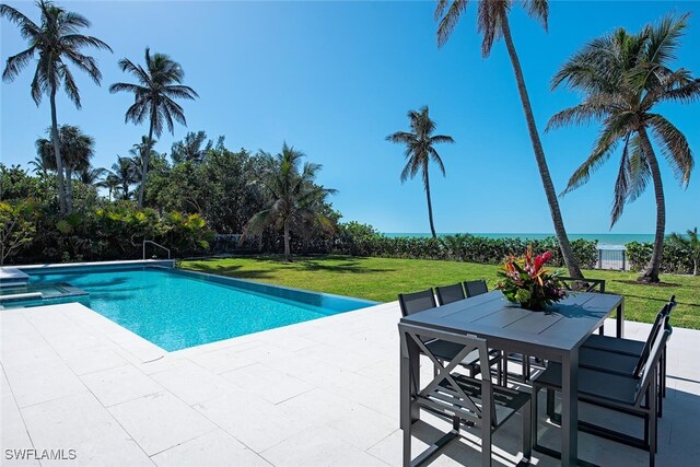 view of swimming pool featuring a patio and a lawn