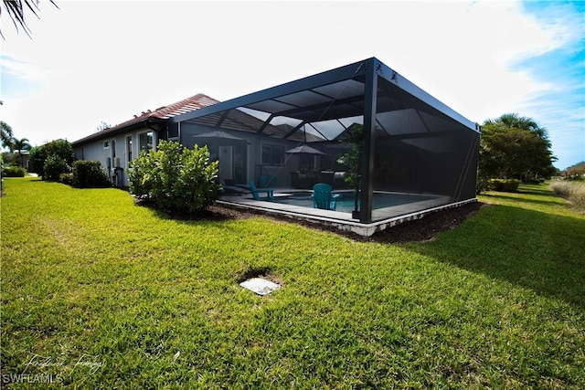 exterior space with a lanai and a lawn