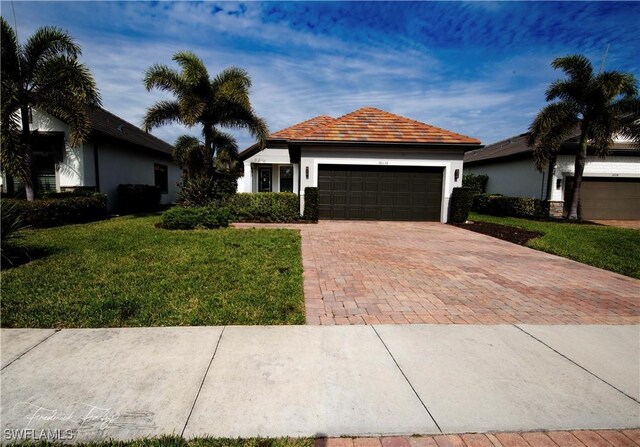 ranch-style house with a front lawn and a garage