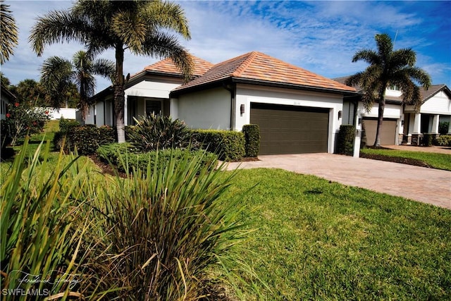 single story home with a front lawn and a garage