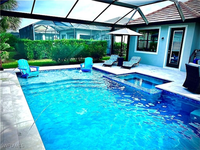 view of swimming pool featuring an in ground hot tub, a patio, and glass enclosure