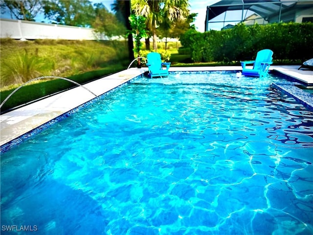 view of swimming pool with pool water feature