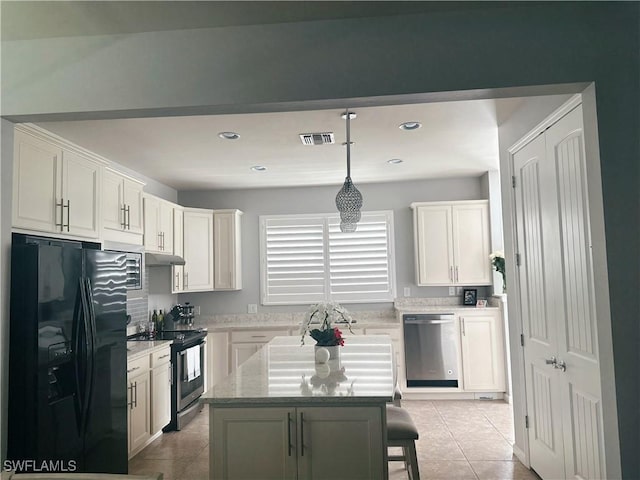 kitchen with light tile patterned floors, stainless steel appliances, visible vents, white cabinetry, and under cabinet range hood