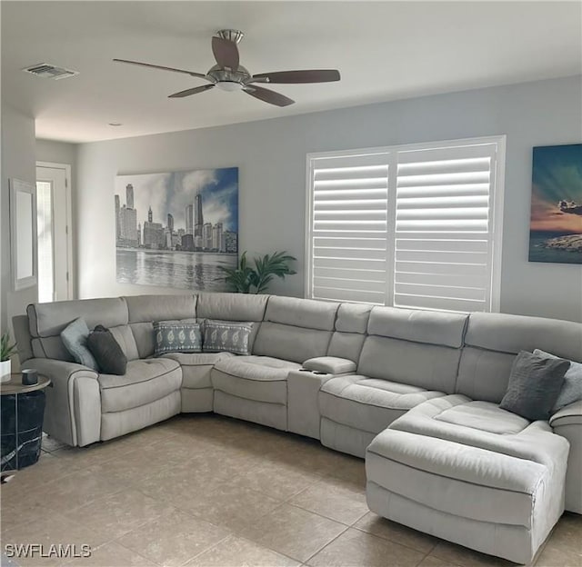 living area featuring a view of city, ceiling fan, and visible vents