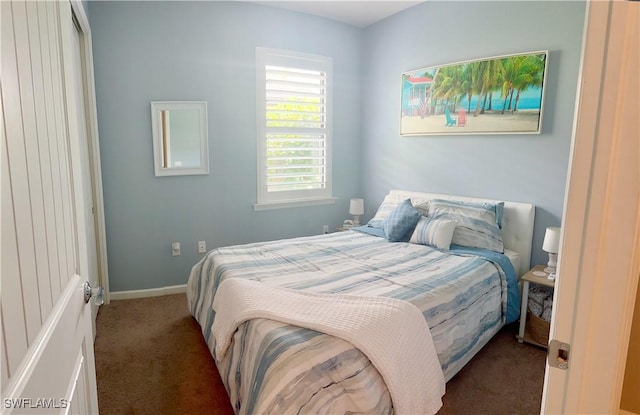 bedroom featuring carpet floors and baseboards