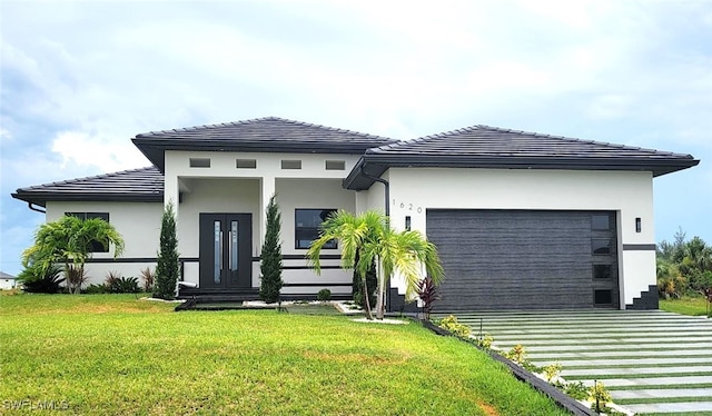 back of property featuring a garage and a yard