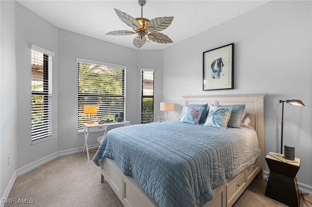 carpeted bedroom with ceiling fan and multiple windows