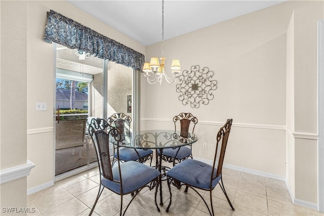 dining space featuring light tile patterned floors and a chandelier