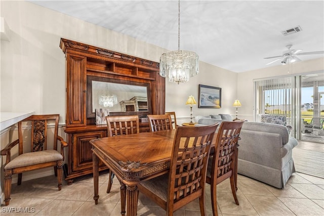 dining room featuring light tile patterned floors and ceiling fan with notable chandelier