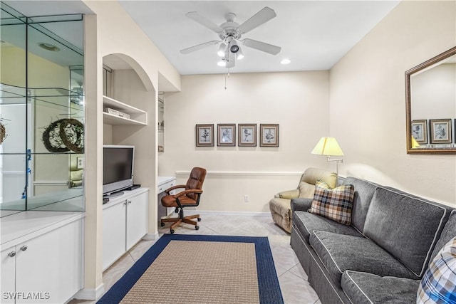 tiled living room featuring built in features and ceiling fan