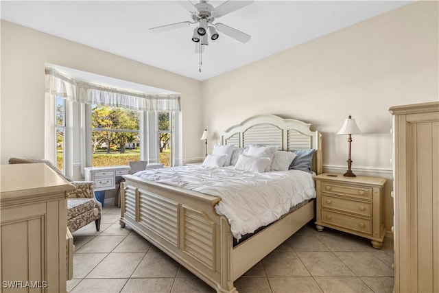 tiled bedroom featuring ceiling fan