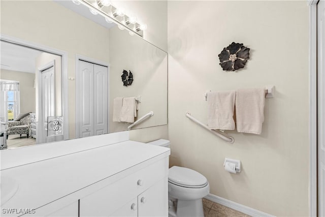 bathroom featuring tile patterned flooring, vanity, and toilet