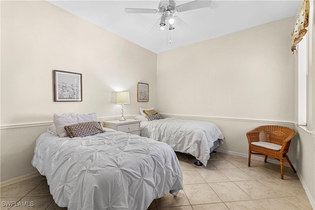 tiled bedroom featuring ceiling fan