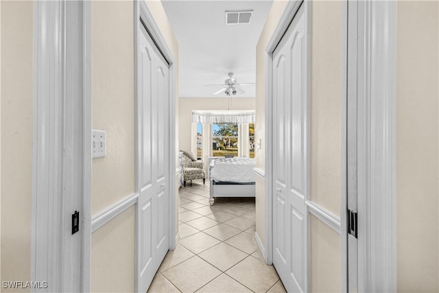 hall with light tile patterned floors