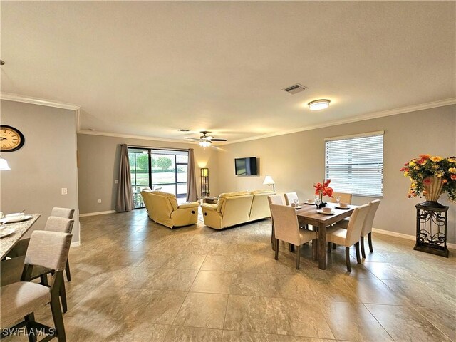 dining space with ceiling fan and ornamental molding