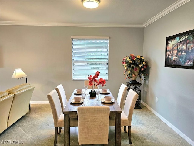 tiled dining room featuring crown molding