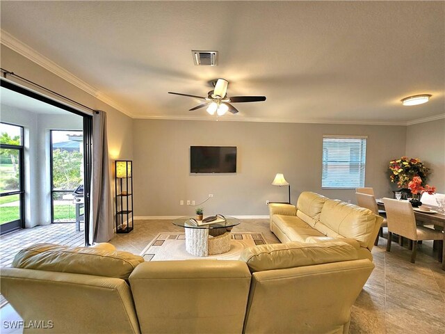 living room featuring ceiling fan, ornamental molding, and light tile patterned flooring