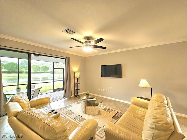 tiled living room with ceiling fan and crown molding