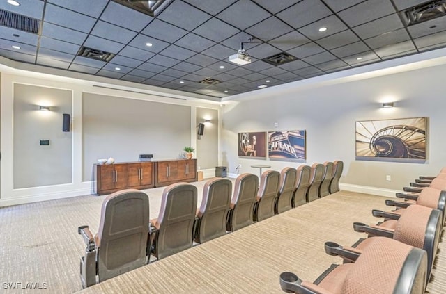 cinema room featuring carpet flooring and a drop ceiling