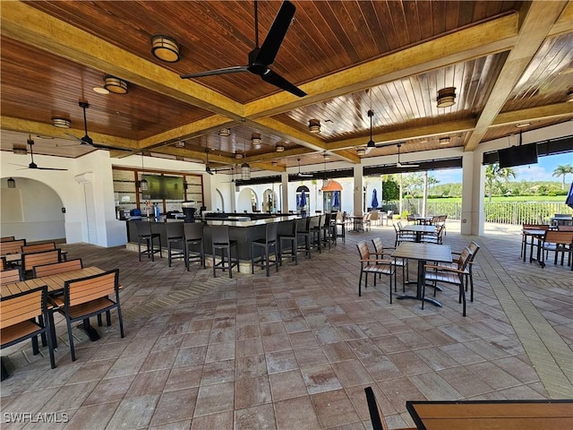 dining space with ceiling fan, beam ceiling, and wood ceiling