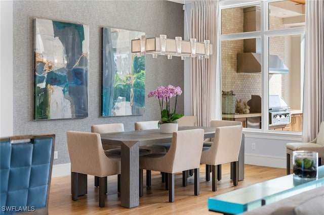 dining area featuring wood finished floors and baseboards