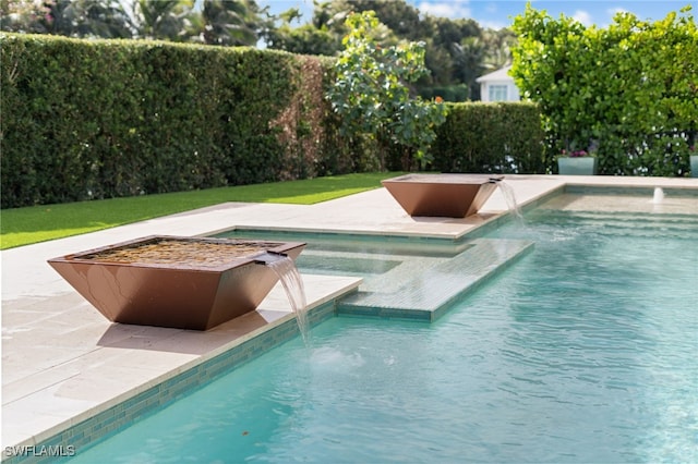 view of swimming pool with a patio area, a fenced in pool, and an in ground hot tub