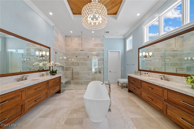 full bath featuring a chandelier, a stall shower, a raised ceiling, and a sink