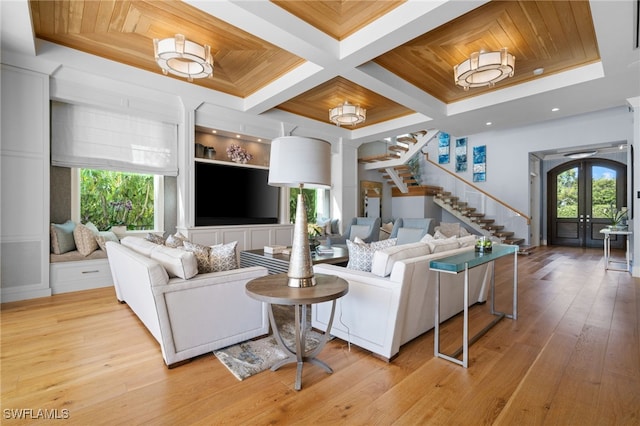 living room with french doors, a wealth of natural light, stairway, and wood ceiling