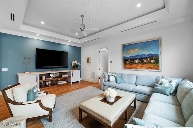 living area with wood ceiling, a tray ceiling, wood finished floors, and recessed lighting