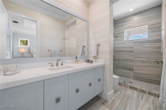 bathroom featuring toilet, a stall shower, visible vents, and vanity