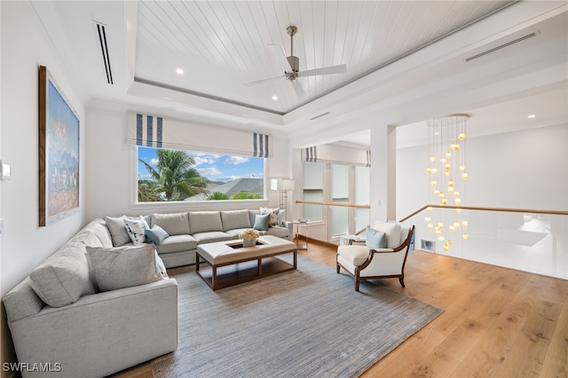 living room featuring visible vents, wooden ceiling, wood finished floors, a tray ceiling, and recessed lighting