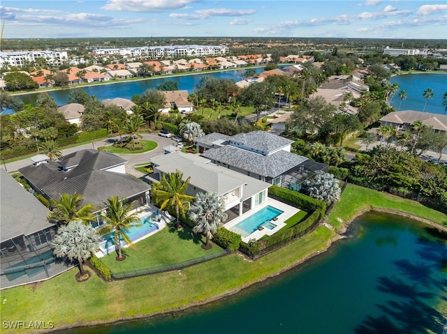 drone / aerial view with a water view and a residential view