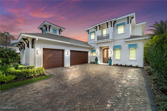 view of front facade with a balcony and a garage