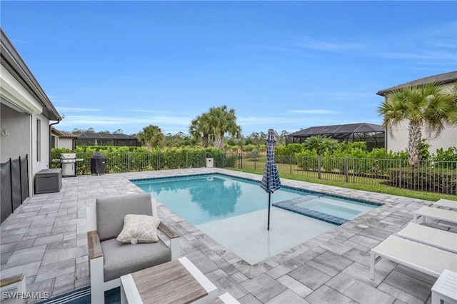 view of swimming pool featuring a patio area, a grill, and an in ground hot tub