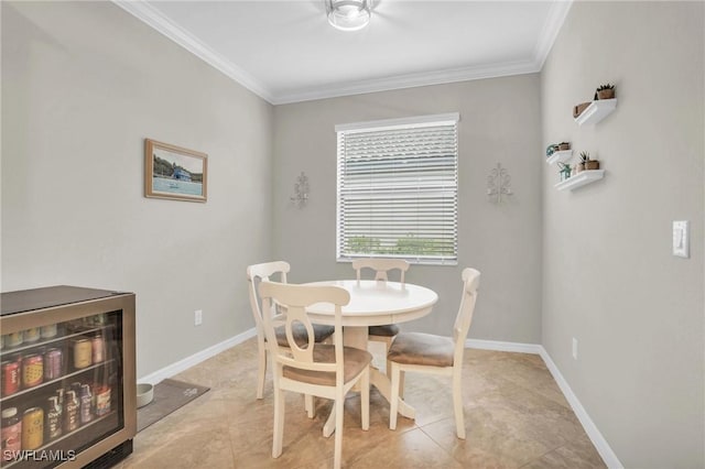 dining area featuring light tile patterned floors, crown molding, and beverage cooler