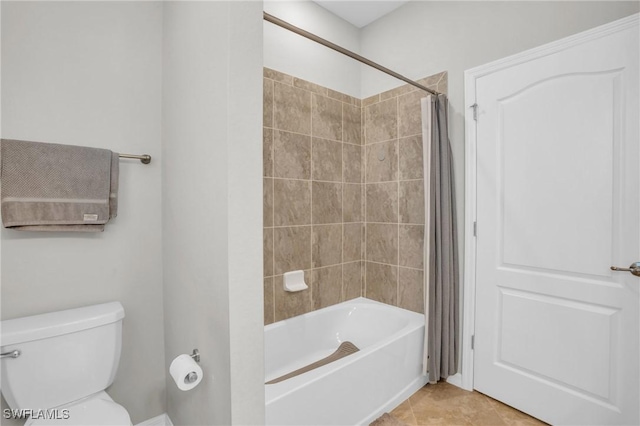 bathroom featuring tile patterned floors, toilet, and shower / tub combo