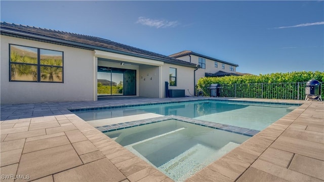 view of pool with an in ground hot tub and a patio area