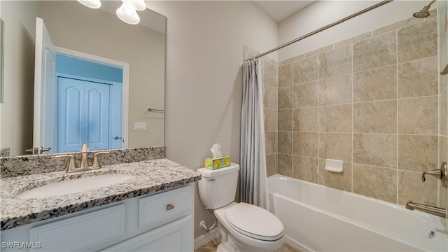 full bathroom featuring toilet, vanity, and shower / bath combo with shower curtain