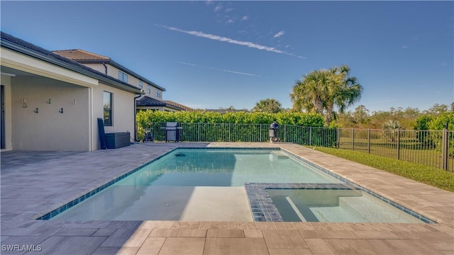 view of pool with area for grilling and a patio