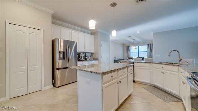 17250 Ashcomb Way, Estero, FL 33928 - kitchen with appliances with stainless steel finishes, a sink, crown molding, a kitchen island, and white cabinets